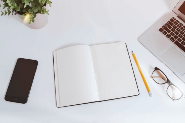 An empty notebook and pencil indicating that simple writing styles are sometimes better