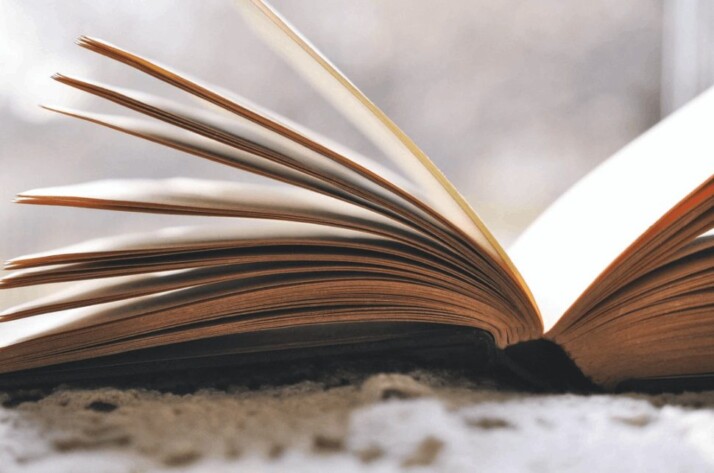 An open book placed on a low pile carpet