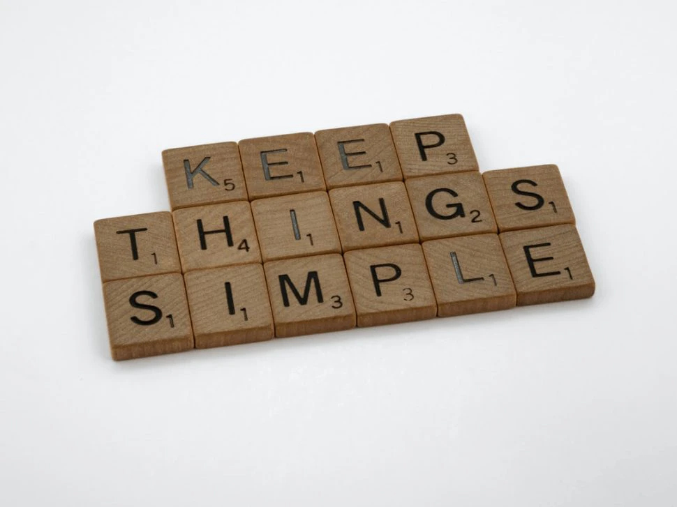 brown wooden blocks on white table that says Keep Things Simple