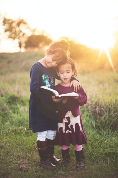 Guided reading practice between two girls so that they can help each other.