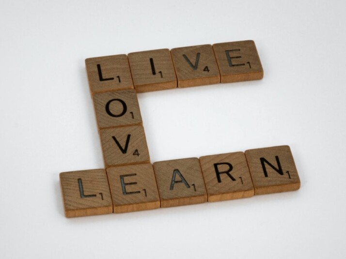 Live Love Learn brown wooden scrabble blocks on a white surface