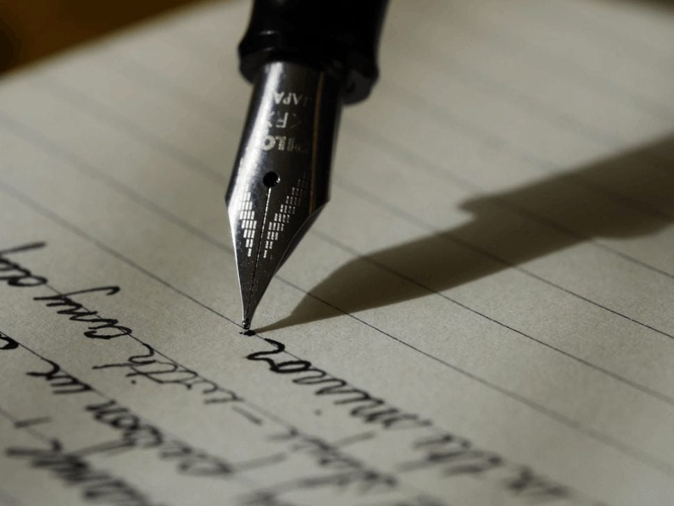 black fountain pen on black lined paper crafting beautifully