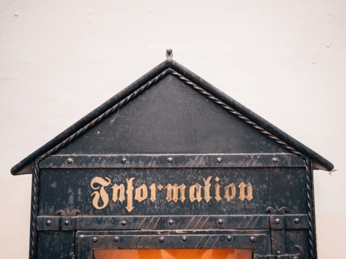 close-up photography of Information signage on a metal box