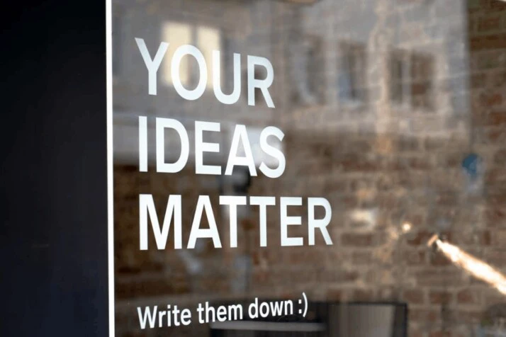 YOUR IDEAS MATTER written on a transparent glass surface.