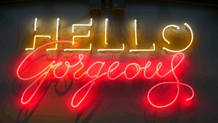 yellow and red Hello Gorgeous neon light signage on a black background