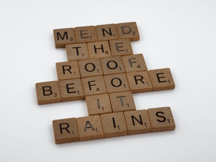 brown wooden blocks that read mend the roof before it rains on white surface.