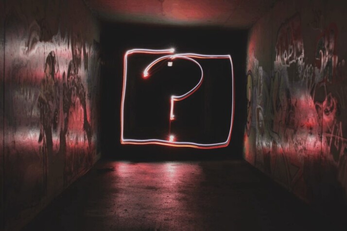 question mark neon signage in a tunnel with aesthetic walls
