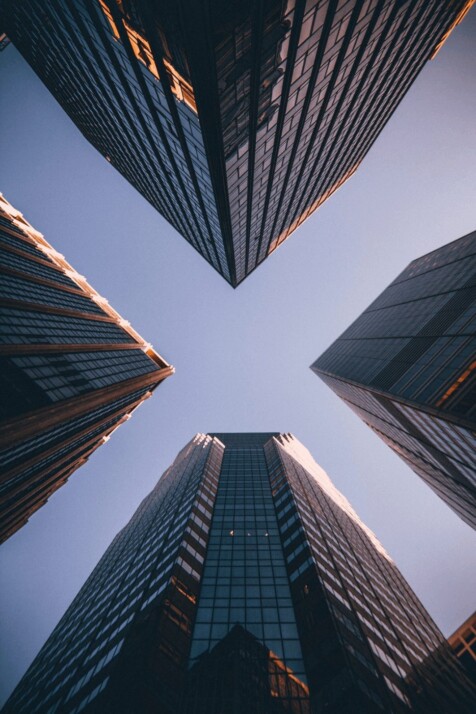 low-angle photography of four high-rise buildings during dawn or dusk.