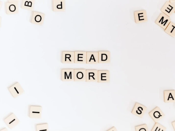 Read More scrabble blocks placed on a white background. 