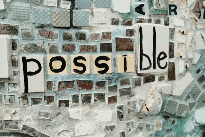 black and white tiles with the word Possible written on them. 