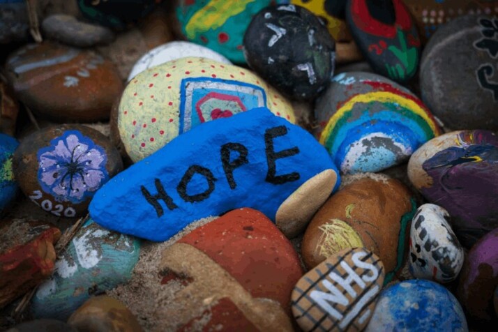 A blue stone with the word Hope written on it.