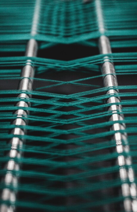 green and white striped textile on parallel long steel