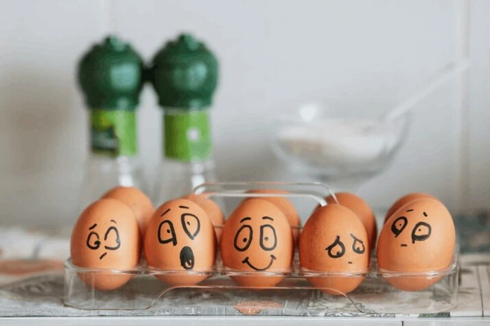 brown eggs with faces drawn to show different emotions. 