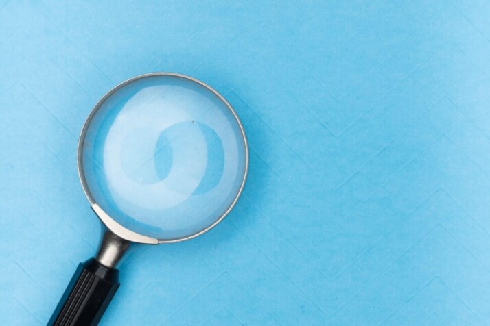 A magnifying glass placed on top of a blue table.