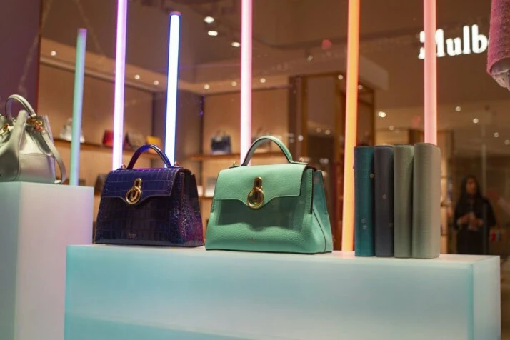 Bags of assorted colors on display in a retail store.