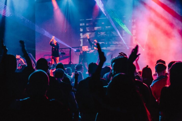 A concert packed with people singing along to the music.