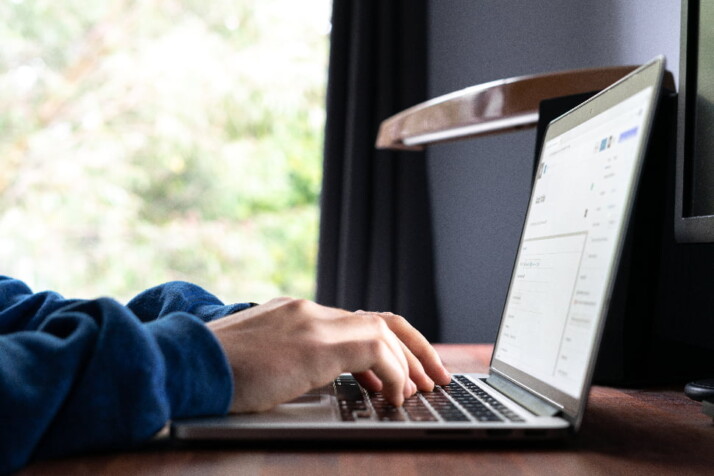 A person who is working on something on his laptop.