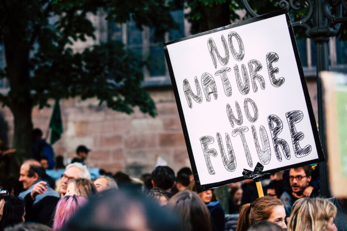 A person holding up a sign that says 