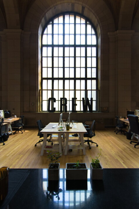 An office with hardwood floors and a sign that says Crew.