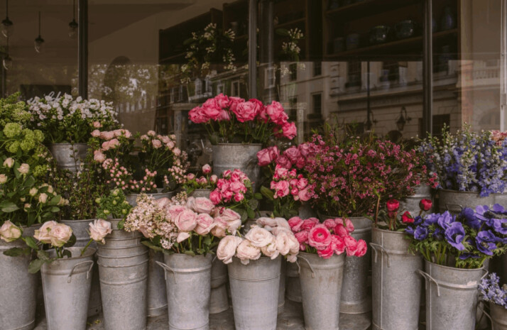 Lots of different pink flowers in gray steel bucket