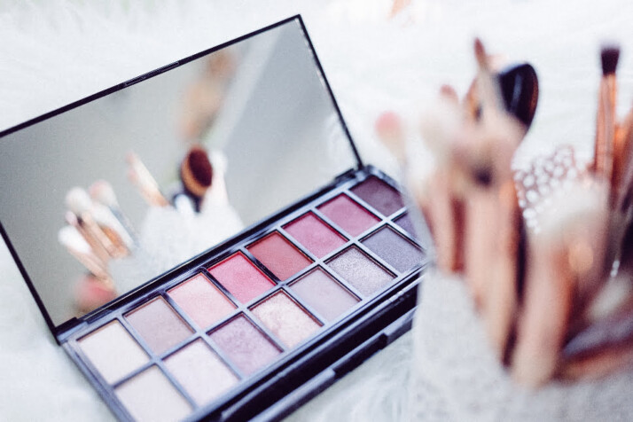 An open eyeshadow palette placed on a white surface. 