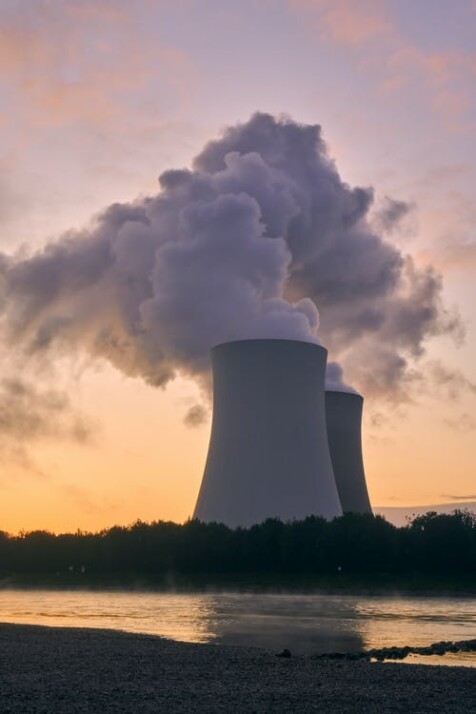 nuclear power plant emitting gas near trees and river 