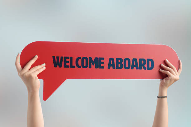 hand holding the welcome aboard written speech bubble picture 