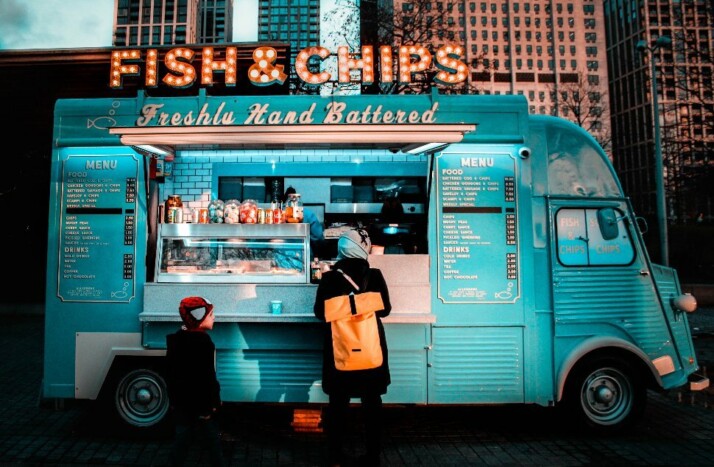 A blue food truck with a signage that says Fish & Chips.