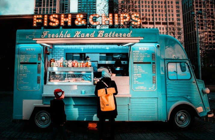 A blue food truck with a signage that says Fish & Chips.