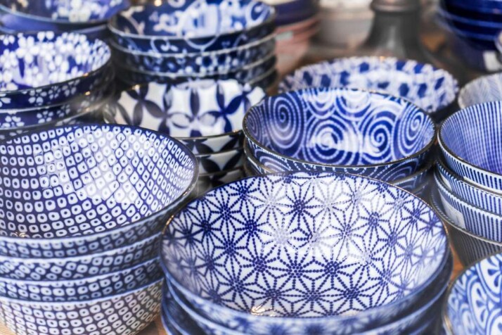 different hand-crafted pottery plates arranged onto of each other