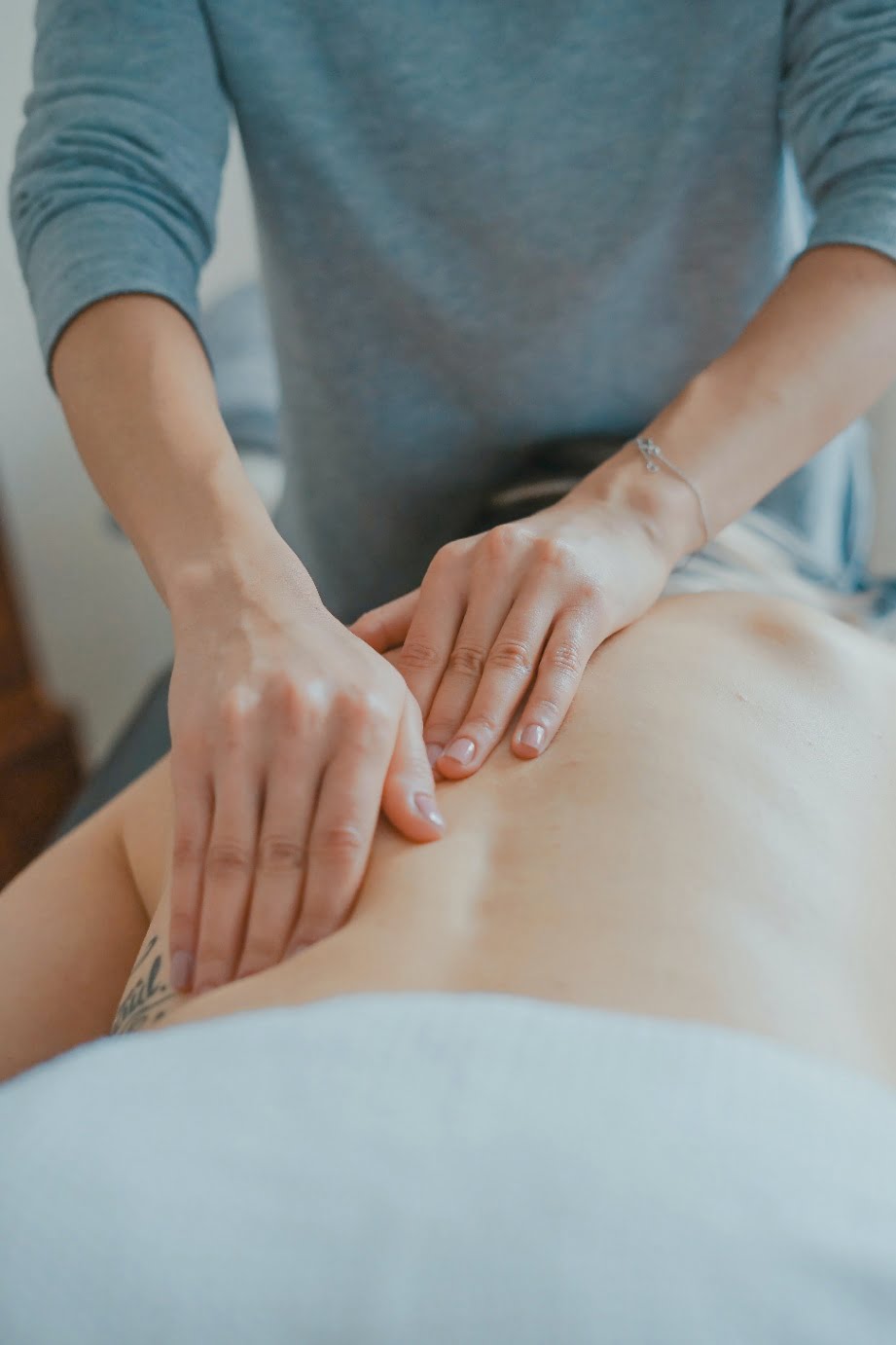 Close-up image of a back massage with the masseuse using their two hands.
