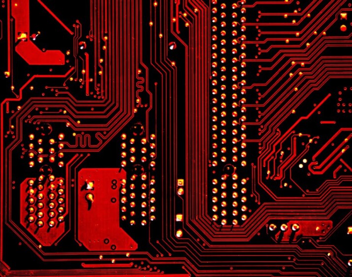 close-up photography of a red circuit board with pins