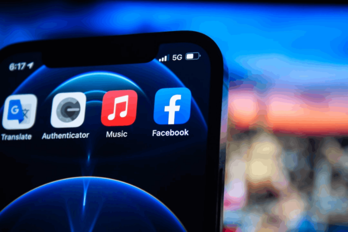 black smartphone showing the Facebook app icon