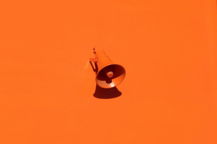 An orange megaphone picture with a similar orange background.