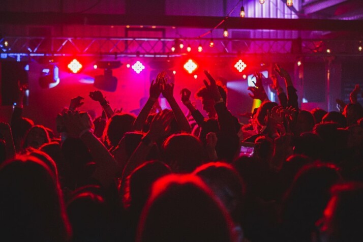 A night club filled with people dancing and partying.