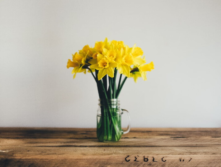 A beautiful set of yellow flowers placed in a mug vase.