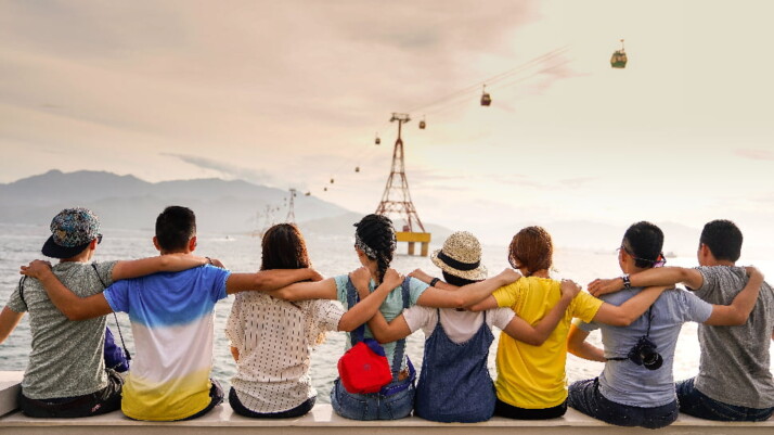 Eight friends looking at the beautiful view of the sky and the water.