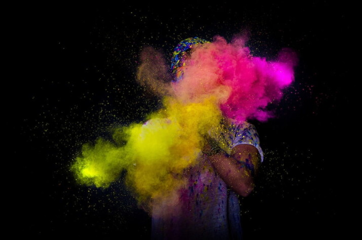 person throwing colored powder