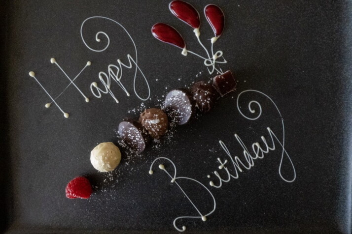 A flat lay of fruits and sweets used as a birthday greeting.