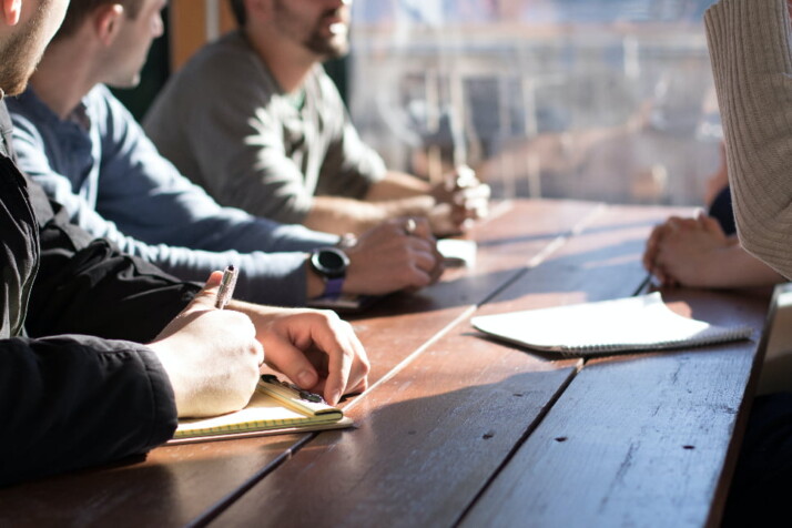 A group of people discussing something in a meeting or interview.