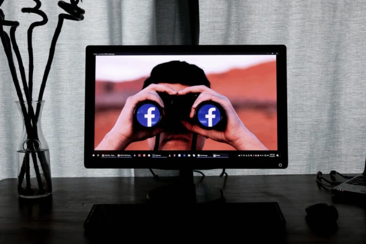 television showing man using binoculars
