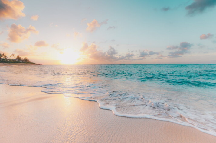 A beautiful view of the pristine beach waters blending perfectly with the sun.