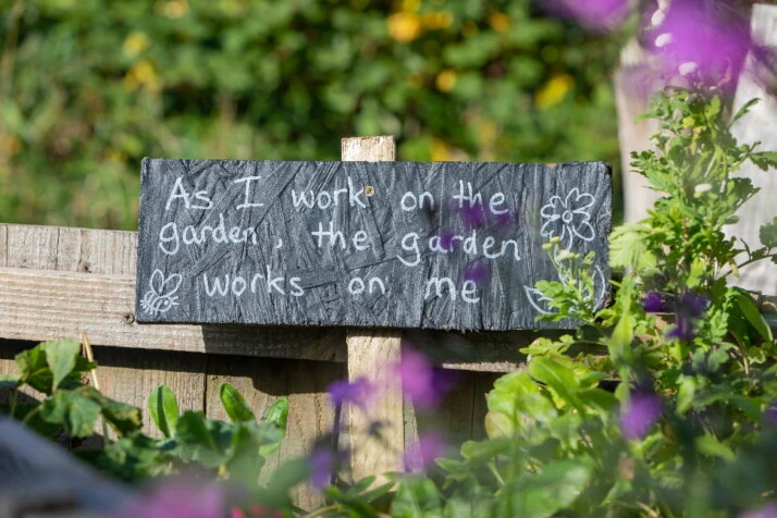 A message in a community garden on the positive aspects of garden