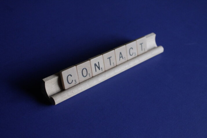 A wooden scrabble rack holding letters that spell 