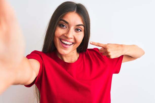 beautiful woman wearing red t-shirt striking pose for selfie