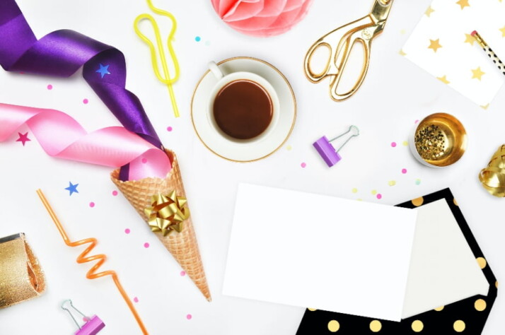 Colorful card making materials scattered across a white table.