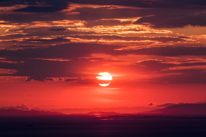 A beautiful view of the sunset staining the skyline with a pink and red hue.