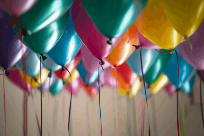 A selective focus photography of a cluster of colorful balloons