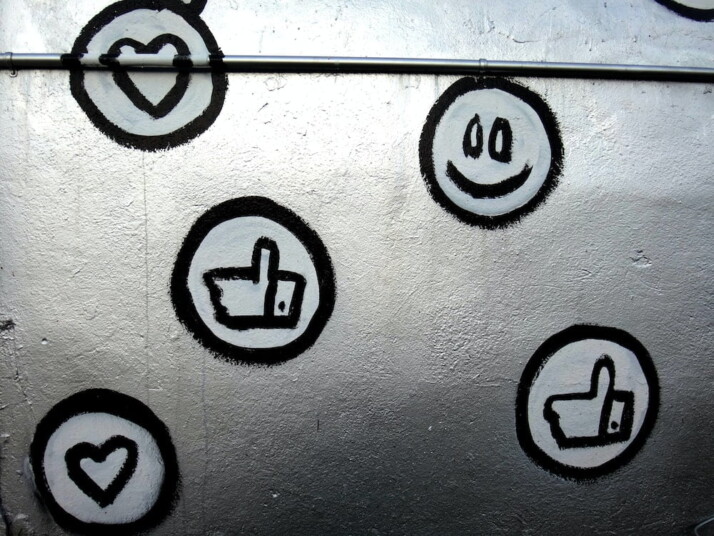 A picture of wall drawings imitating Facebook likes and reactions.