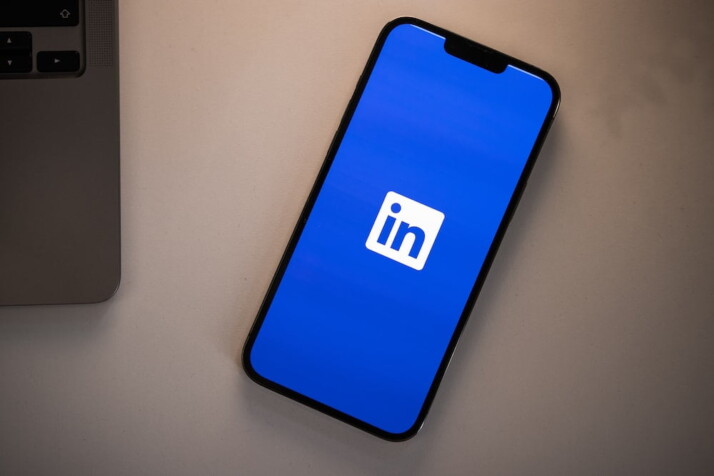 Picture of an iPhone with the LinkedIn app logo.